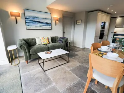 a living room with a couch and a table at The Elterwater Barn in Workington