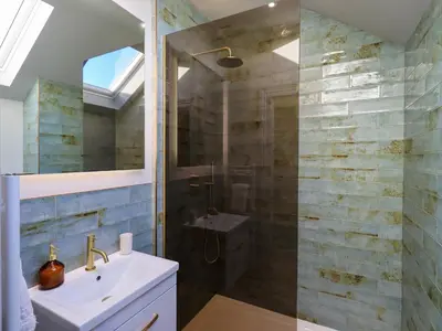 a bathroom with a sink and a shower at The Elterwater Barn in Workington
