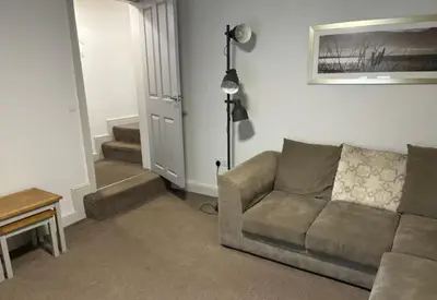 a living room with a couch and a table at Unique, Large 2 bedroom Flat in Carlisle
