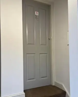 an empty hallway with a white door in a building at Unique, Large 2 bedroom Flat in Carlisle