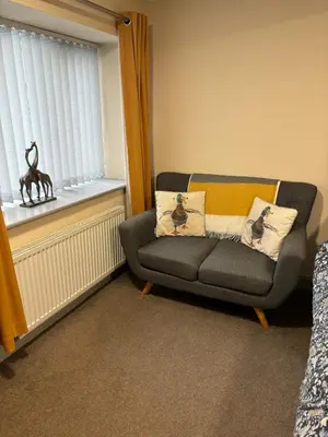 a living room with a couch and a window at Ground Floor Studio in Longtown