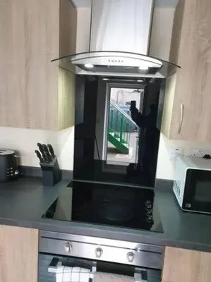 a kitchen with a microwave and a stove top oven at Ground Floor Studio in Longtown
