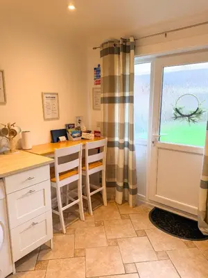 a kitchen with a table and chairs and a window at The Retreat, self-contained cosy Anex, M6 A75 Gretna Green in Rigg