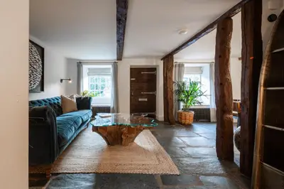 a living room with a couch and a table at Grange Bridge Cottage in Grange