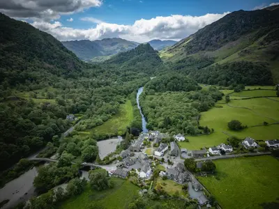 an aerial view of a village in the mountains at Grange Bridge Cottage in Grange