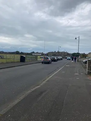 a street with cars parked on the side of the road at The Bunker, Golf Cottage in Prestwick