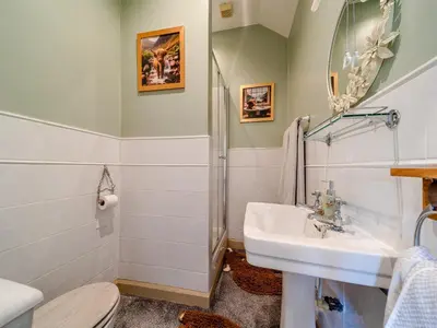 a bathroom with a sink and a shower at Mossknowe Escape in Annan