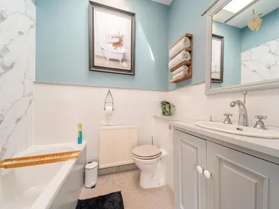 a bathroom with a toilet and a sink at Mossknowe Escape in Annan