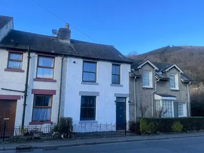 a white house on the side of a street at Greta House in Keswick