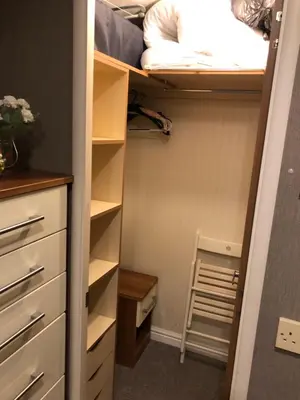 a closet with a bed and a ladder in it at Woodland Lodge in Plumbland