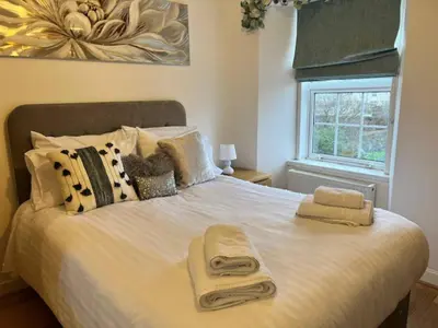 a bedroom with a bed with two towels on it at Harbour View Irvine in Irvine
