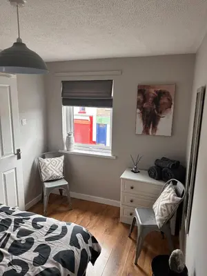 a bedroom with a bed and a window and a chair at A Cozy One Bedroom Flat for Two Guests in Carlisle