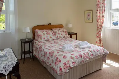 a bedroom with a bed with two towels on it at No1 Chapelton Cottage in Kirkcudbright