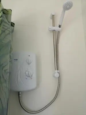 a shower in a wall with a shower head at Carlisle Homestay - Family Room in Carlisle