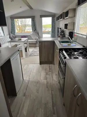 a kitchen with a stove top oven in a room at 131 Loch View Three Lochs Holiday Park in Newton Stewart
