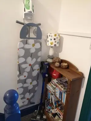 a room with a bed and a shelf with books at Carlisle Homestay - Double Room in Carlisle