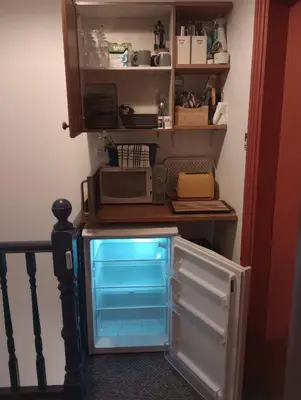 a refrigerator with its door open next to a microwave at Carlisle Homestay - Double Room in Carlisle