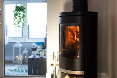 a fireplace in a living room with a fire place at Hidden Hive in Gretna
