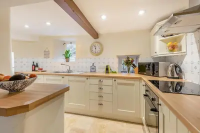 a kitchen with white cabinets and a bowl of fruit at 2 Bed in Greystoke oc-s30412 in Greystoke