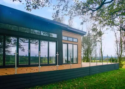a house with a blue roof and windows at Eden Lodge Retreat in Crosby