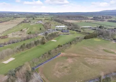 an aerial view of a golf course with trees and fields at Eden Lodge Retreat in Crosby