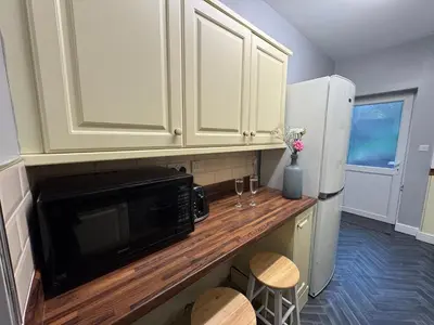 a kitchen with a counter with a microwave and a refrigerator at Omega Apartment - 3 Bedrooms - Sleeps 5 in Whitehaven