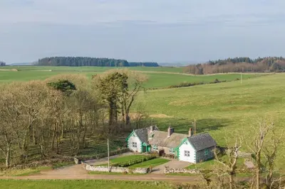 an aerial view of a house in a field at No2 Chapelton Cottage in Kirkcudbright