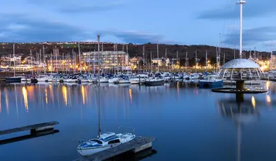 a bunch of boats in a marina at night at Modern Junior Suite, Seascale, Cumbria in Seascale