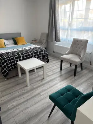 a bedroom with a bed and a chair and a table at private Studio with its own kitchen and bathroom in Moffat