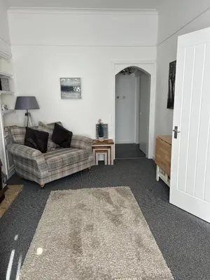 a living room with a couch and a table at Hillhead Apartment in Coylton