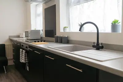 a kitchen counter with a sink and a window at Carlisle Comfort Terrace in Carlisle