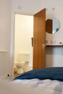 a room with a bed and a bathroom with a toilet at Carlisle Comfort Terrace in Carlisle