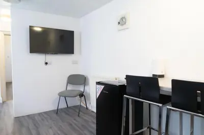 a room with a desk and a chair and a flat screen tv at Carlisle Comfort Terrace in Carlisle