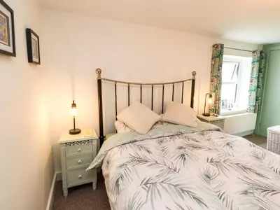 a bedroom with a bed and a lamp on a night stand at Seahaven in Maryport