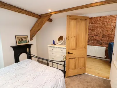 a bedroom with a bed and a brick wall at Seahaven in Maryport