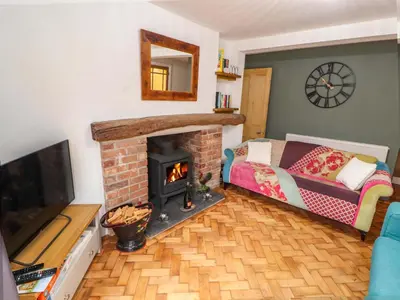 a living room with a fireplace and a couch at Seahaven in Maryport