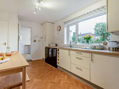 a kitchen with white cabinets and a large window at 3 Bed in Keswick 95858 in Keswick