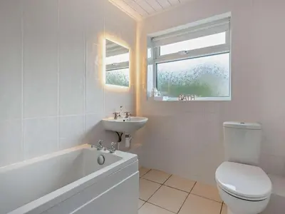 a white bathroom with a toilet and a sink at 3 Bed in Keswick 95858 in Keswick