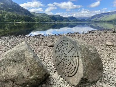 a rock with a design on it next to a body of water at 3 Bed in Keswick 95858 in Keswick