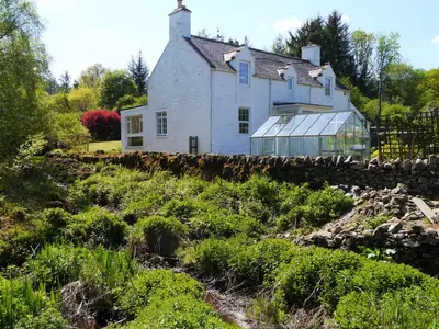 an old house on a hill with a garden at Shinnel House in Thornhill