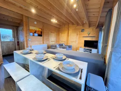 a living room with a table with dishes on it at Beautiful Countryside Lodge with Outstanding Views - Pass the Keys in Dumfries