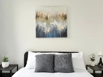 a bedroom with a bed and a painting on the wall at Workington Home - Working - Visiting the Lakes in Workington