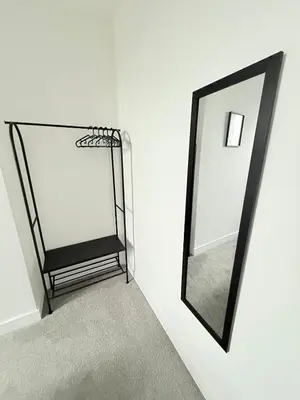 a mirror sitting on a wall next to a hallway at Workington Home - Working - Visiting the Lakes in Workington