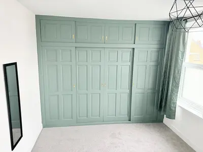 a green garage door in a room with a window at Workington Home - Working - Visiting the Lakes in Workington