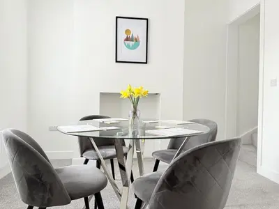 a dining room with a glass table and chairs at Workington Home - Working - Visiting the Lakes in Workington