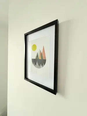 a framed picture of mountains on a wall at Workington Home - Working - Visiting the Lakes in Workington