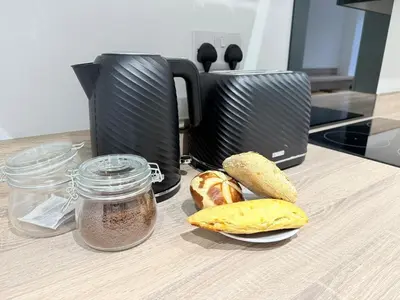 aounter with a toaster and a plate of bread and a jar of ch at Workington Home - Working - Visiting the Lakes in Workington
