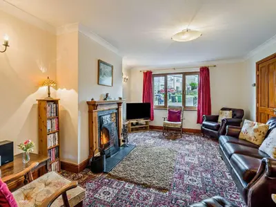 a living room with a couch and a fireplace at 3 Bed in Wigton oc-95374 in Uldale