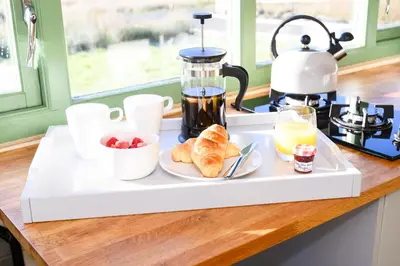 a tray with breakfast food on a kitchen counter at Barnharrow Holiday Pods in Newton Stewart