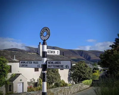 a street sign with several signs on a pole at Oakside Cottage Braithwaite in Braithwaite